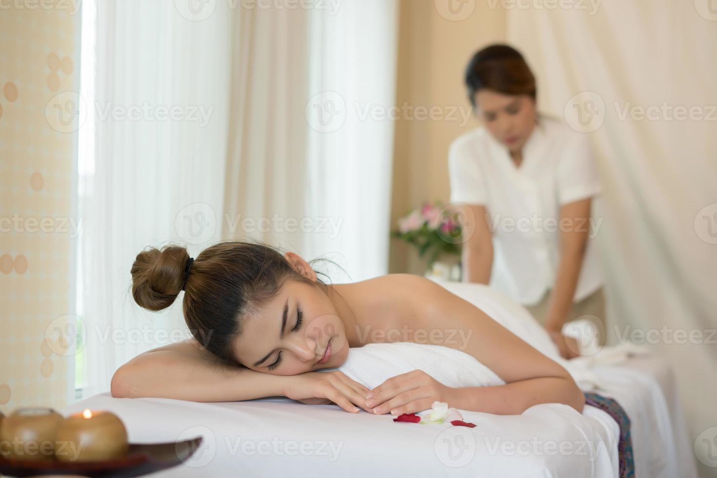 Young beautiful woman with healthy massage in a spa salon photo