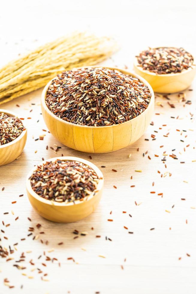 Raw brown rice in wooden bowl photo