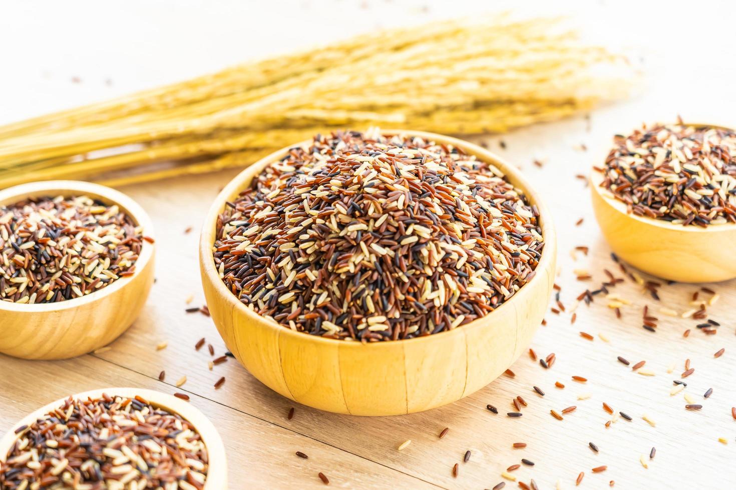 Raw brown rice in wooden bowl photo