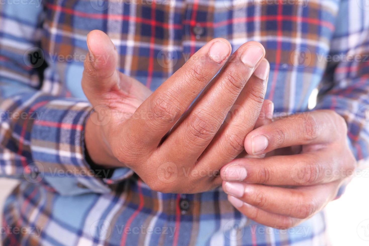 Man suffering from pain in hand close up photo