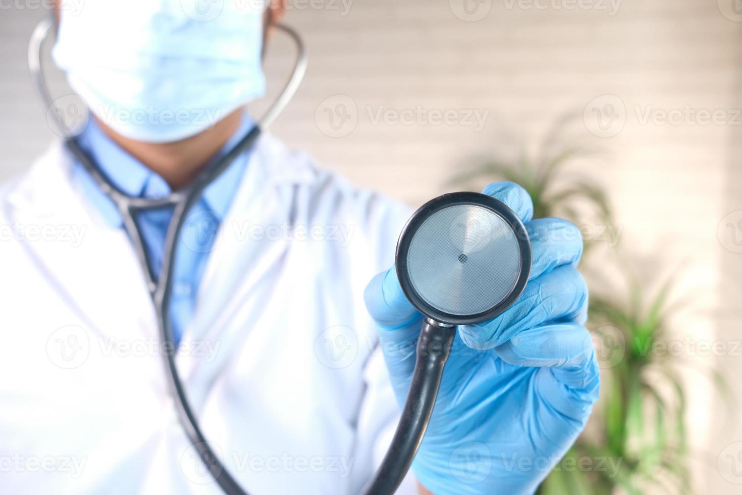 Close up of doctor's hand using stethoscope photo