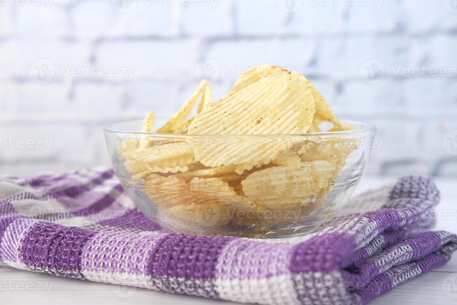 Bowl with tasty potato chips photo