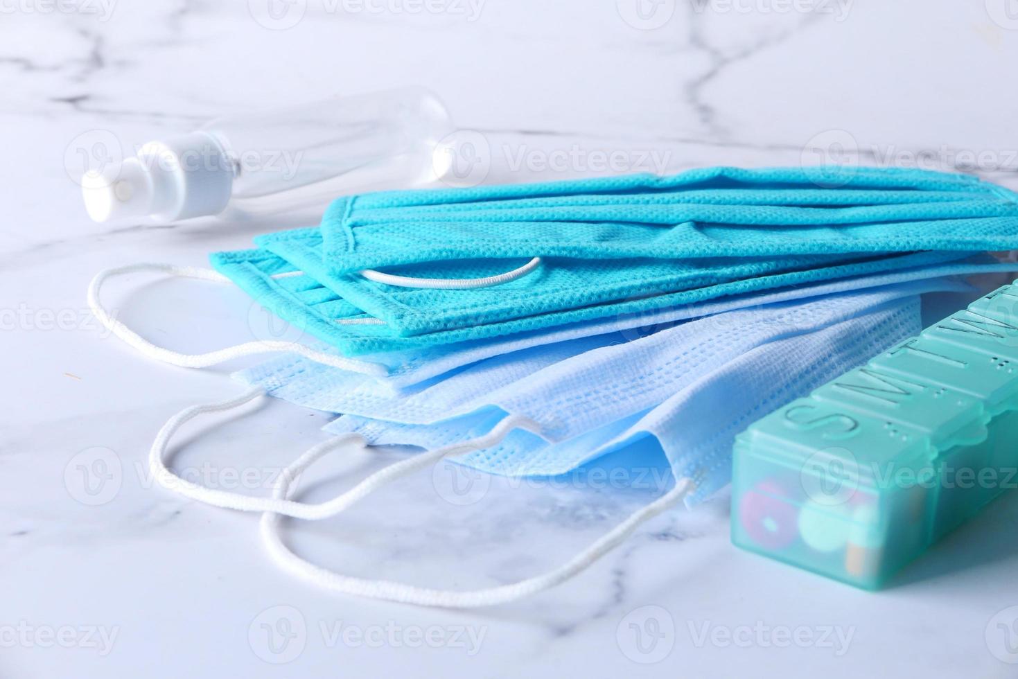 Close up of pills and surgical masks on table photo