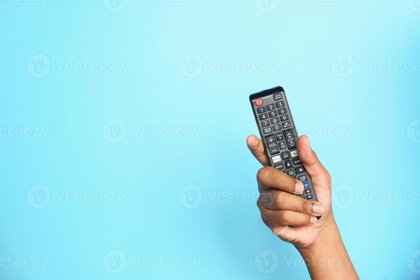 TV remote on blue background photo