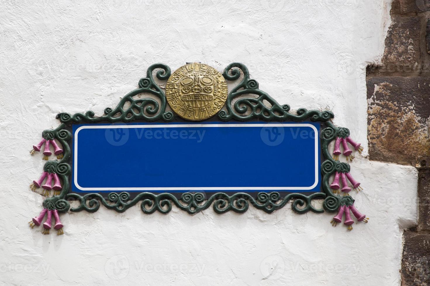 Blank empty blue street sign on a plastered wall photo