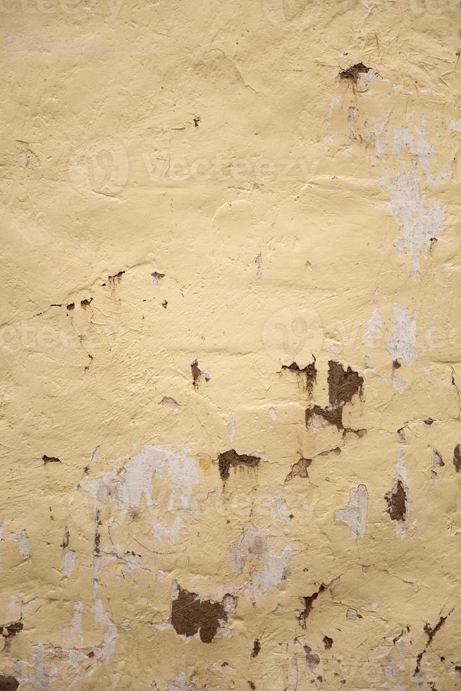 Weathered yellow mud wall photo
