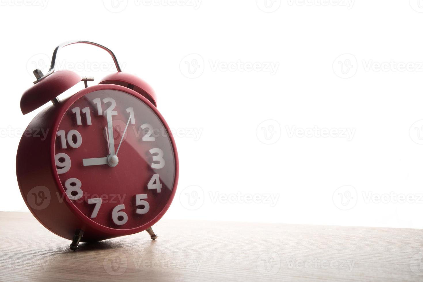 Red alarm clock isolated on white background photo