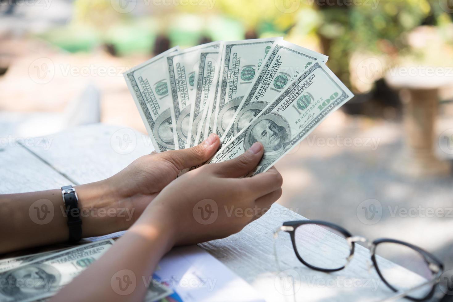 Dollars in womans' hands photo