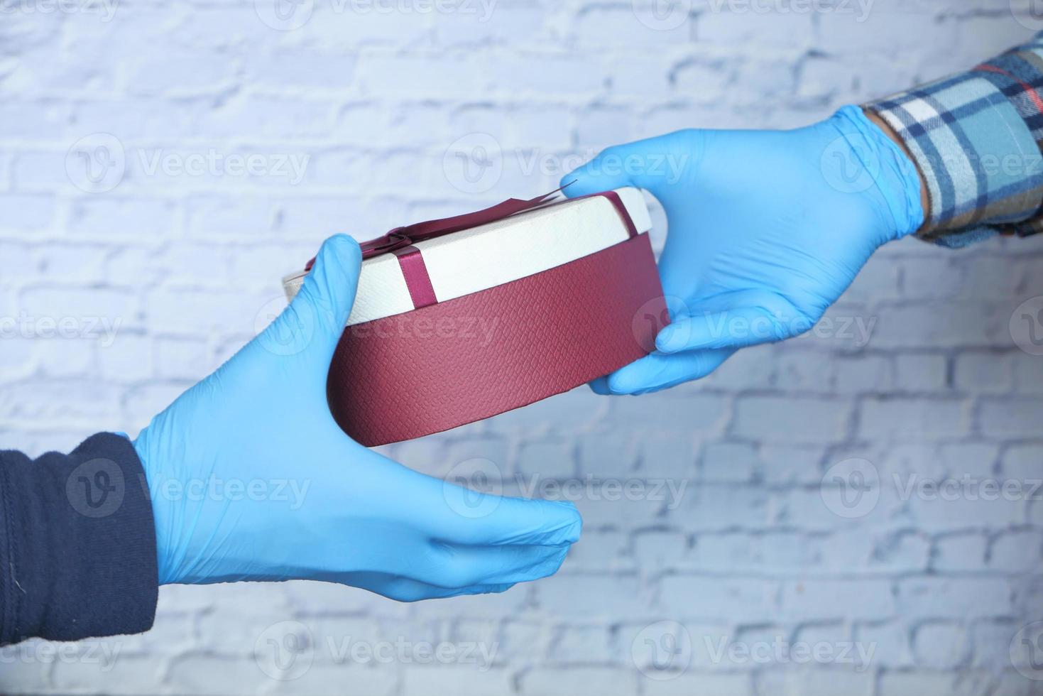 Hand in gloves holding a gifts photo