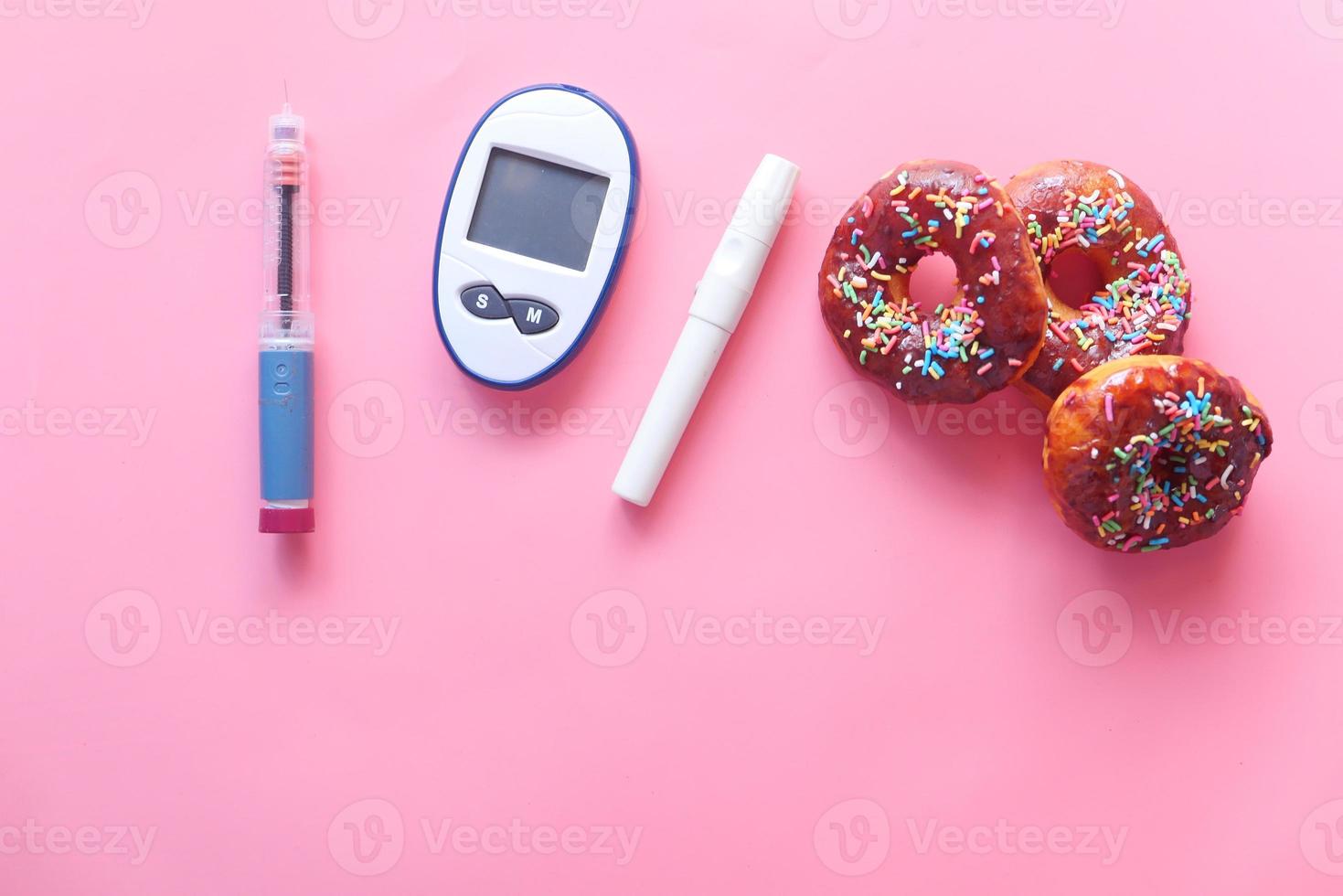 Donuts and diabetic measuring tools photo