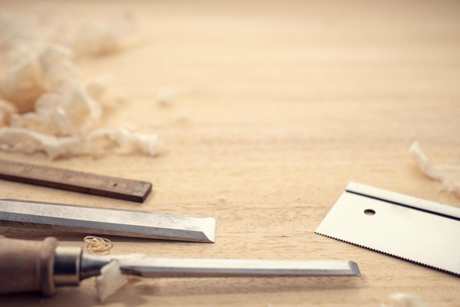 Carpentry or woodworking background with copy space. Carpentry tools and wood shavings on a table photo