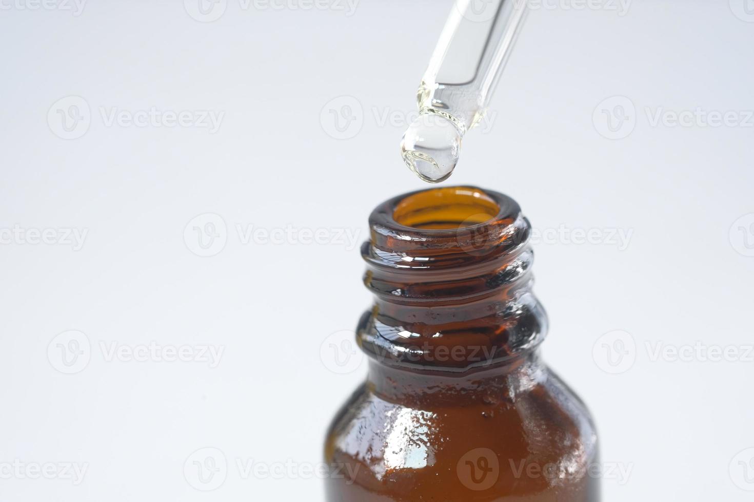 Drop falling from a pipette photo