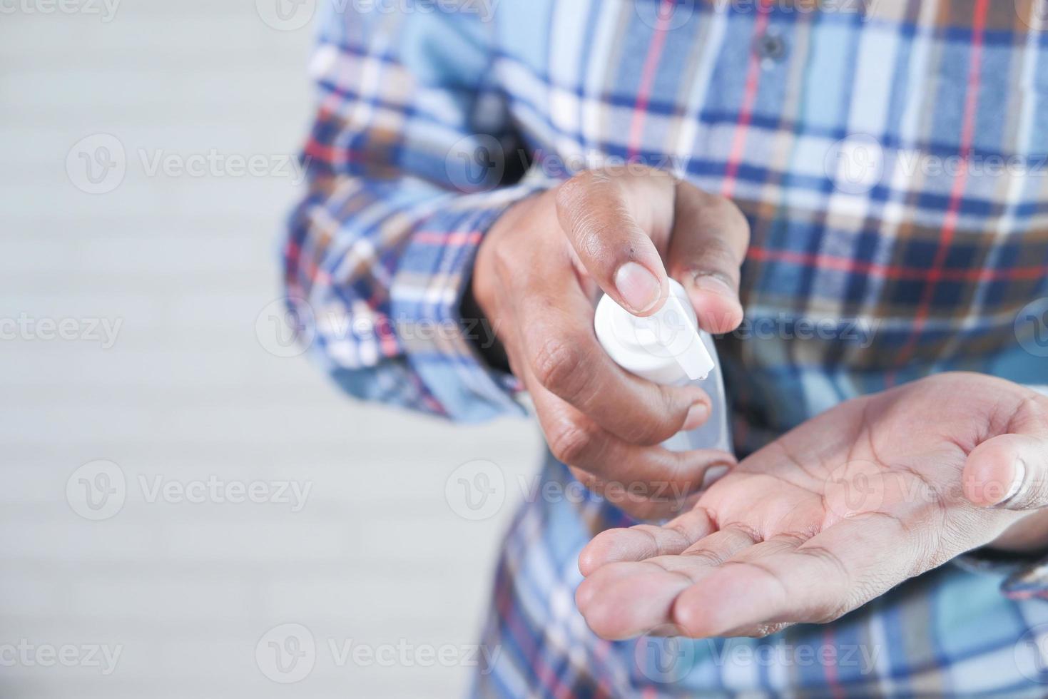 Man using sanitizer gel for preventing virus photo