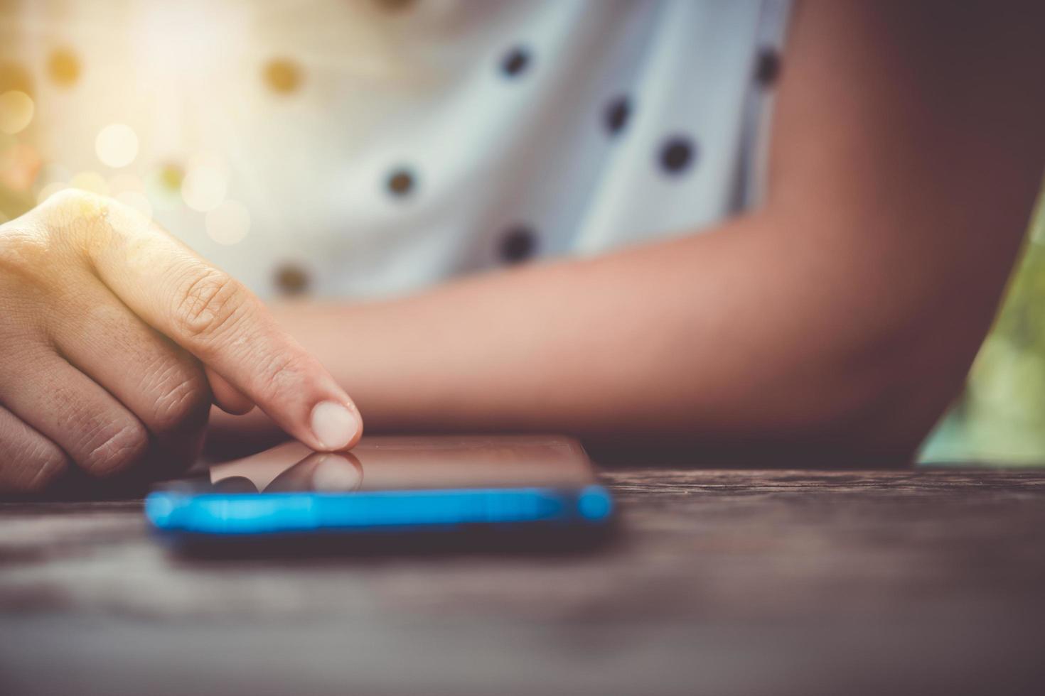 mano de mujer usando un teléfono inteligente foto