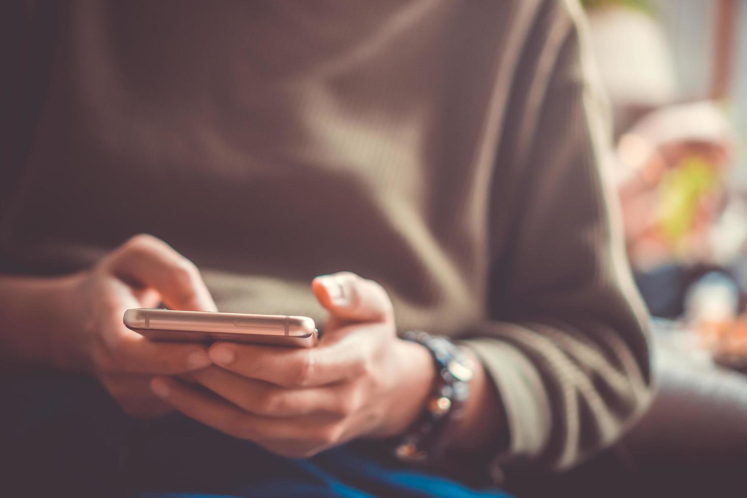 Woman's hand using a smartphone photo