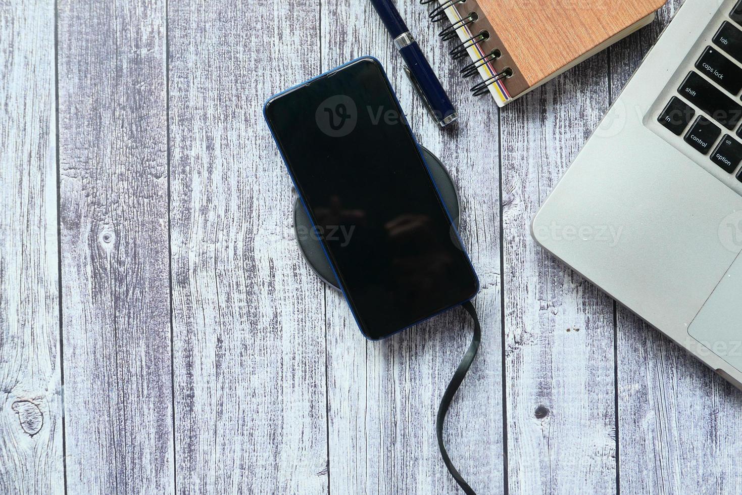 Charging a phone on desk top photo