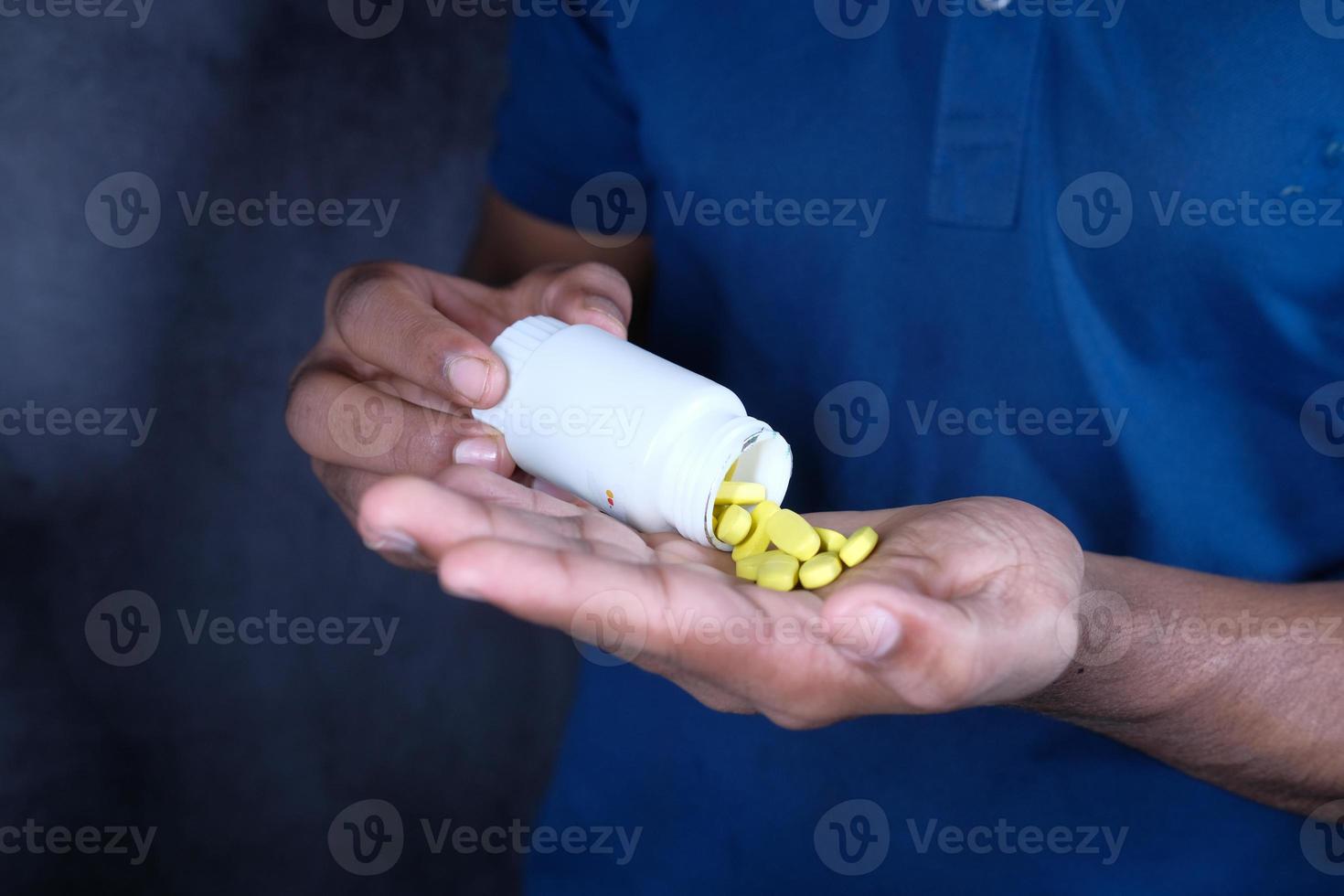 Man using yellow pills photo