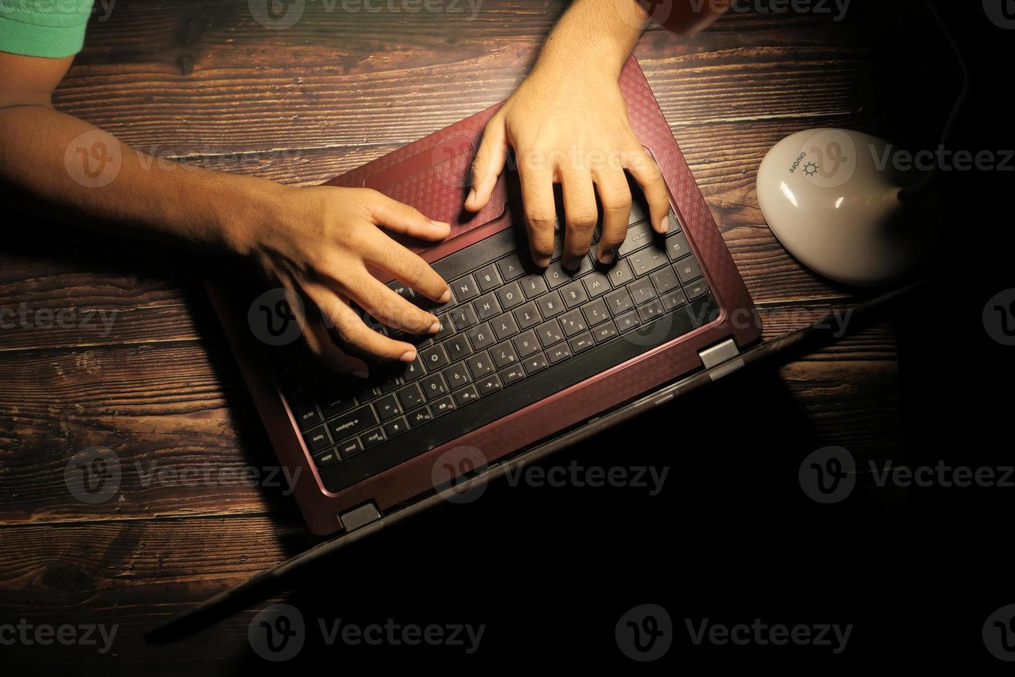 Hacker's hands using laptop photo