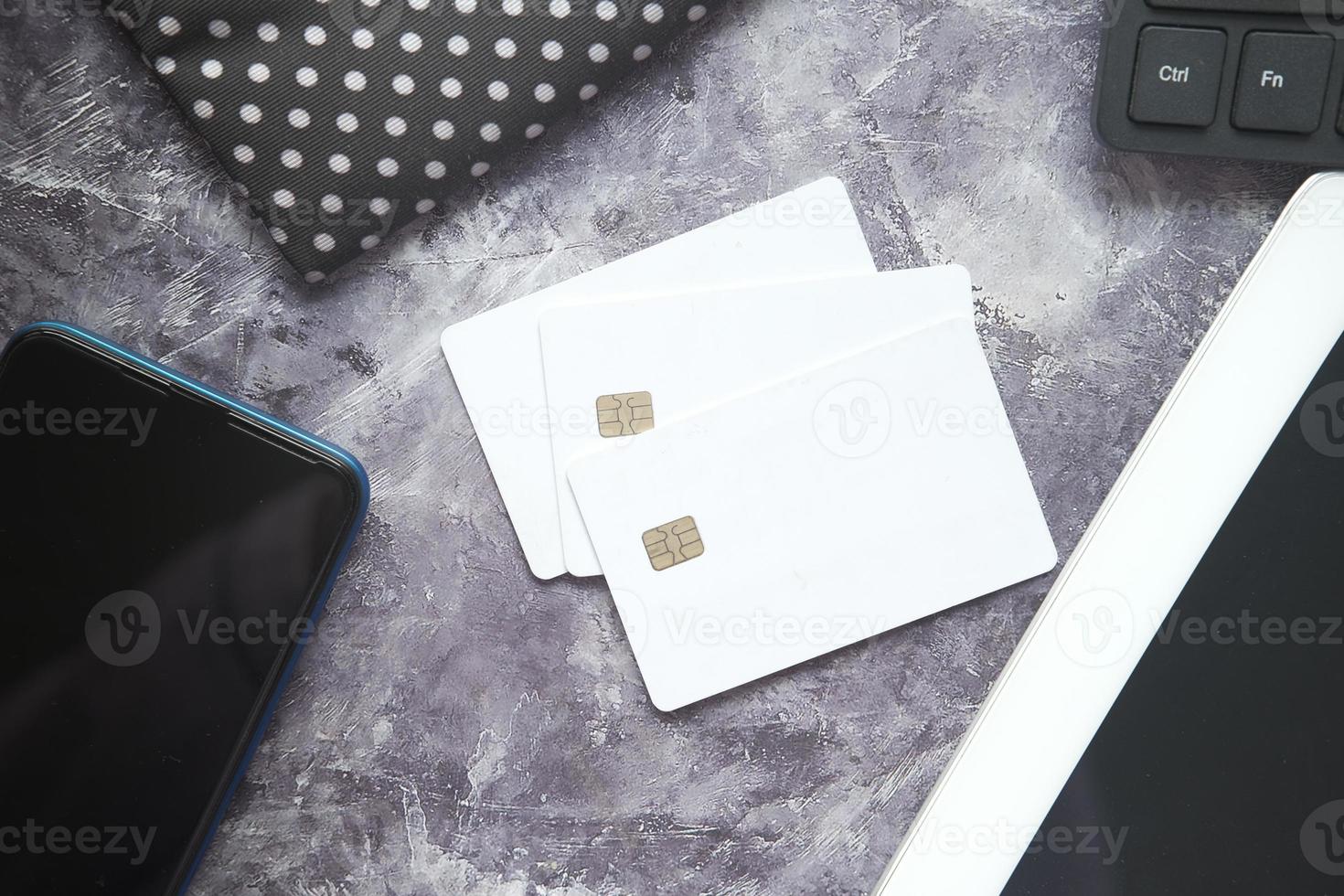 White credit cards on monochromatic desk top photo