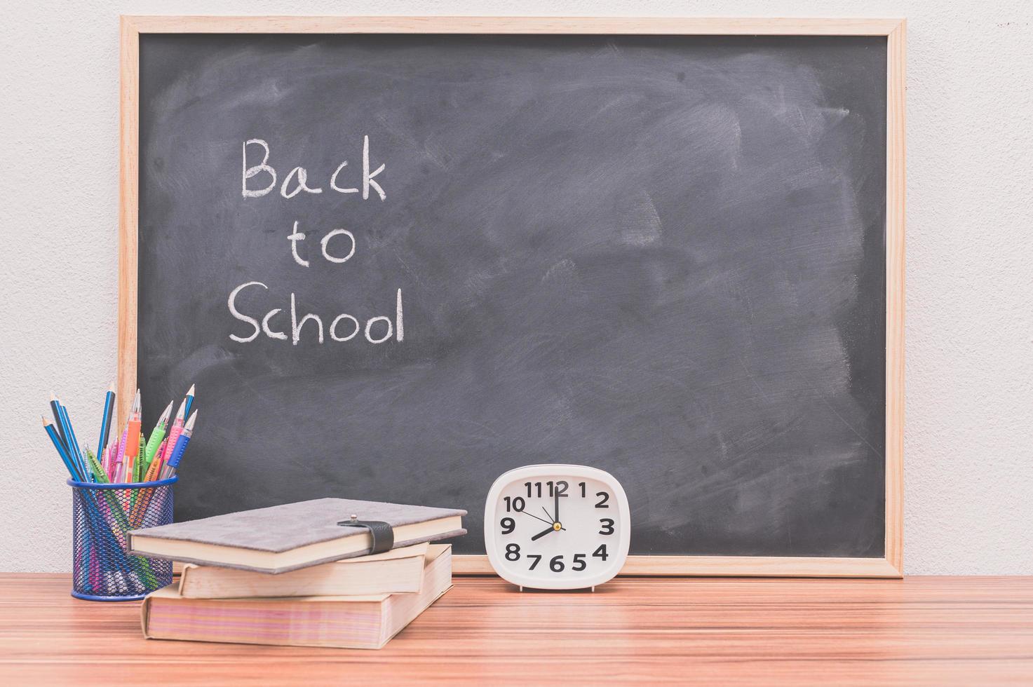 Back to school words written on chalkboard background photo