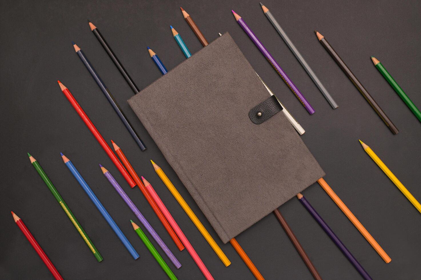 Book and colored pencils Back to school and education concept photo