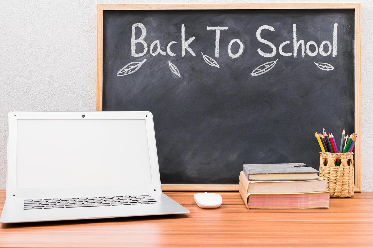 Back to school words written on chalkboard background photo