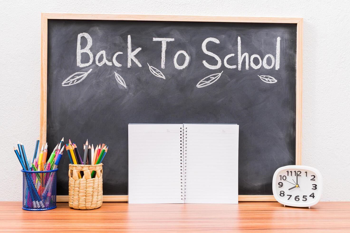 Back to school words written on chalkboard background photo