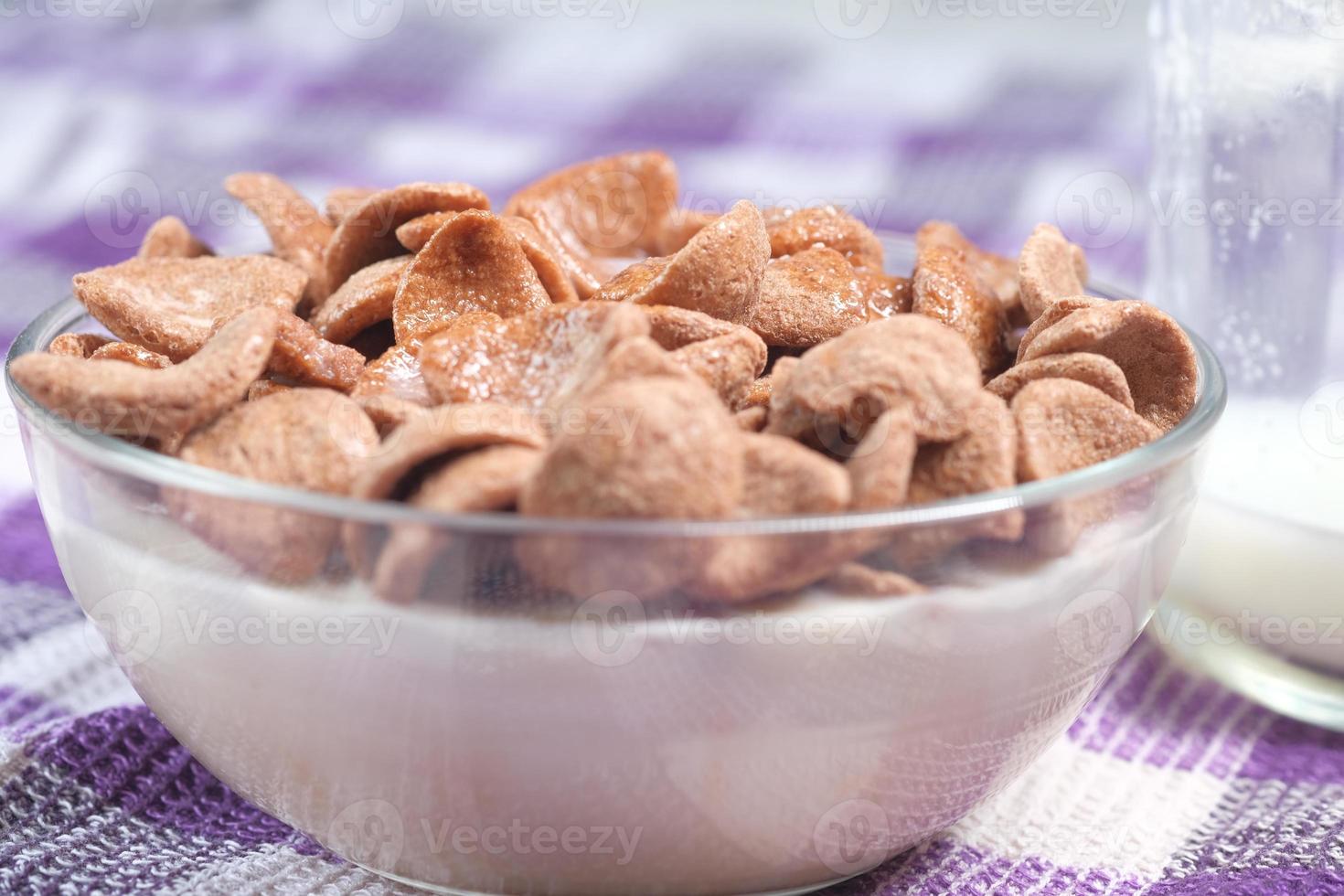 Corn flakes and milk on table photo