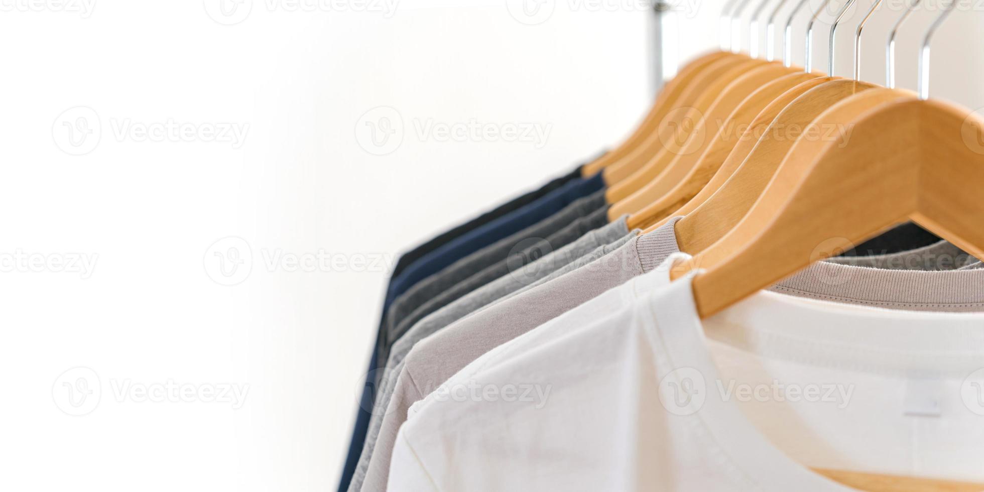 Close up of t-shirts on hangers, apparel background photo