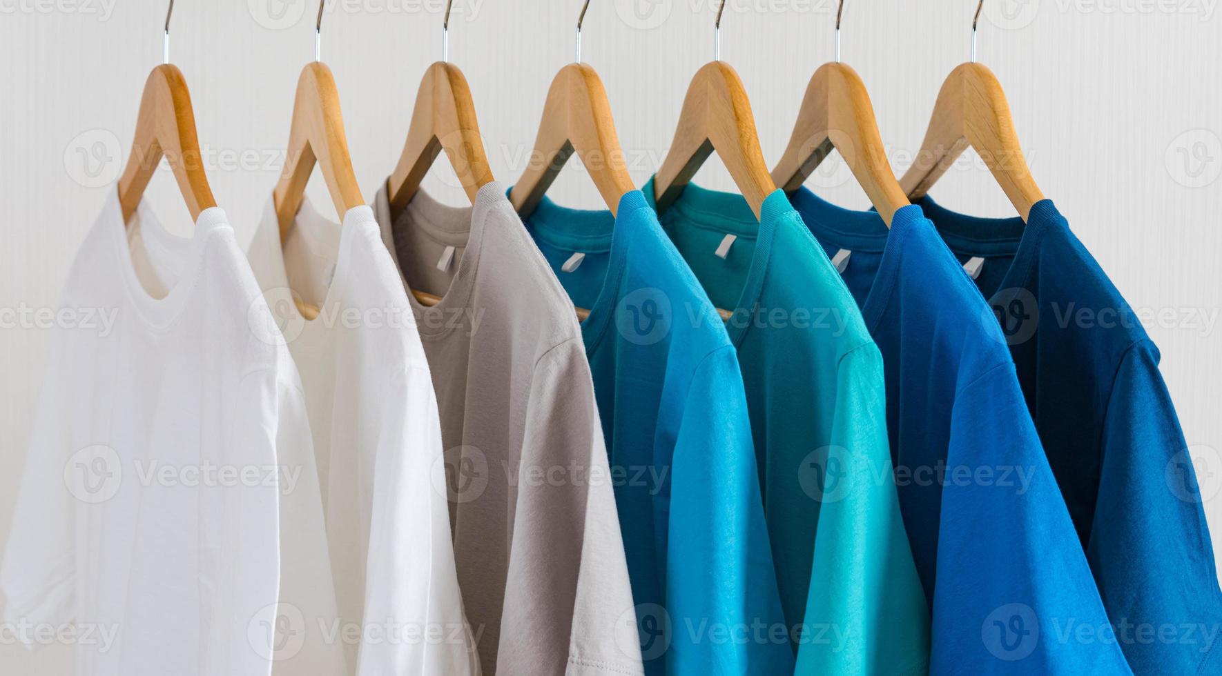 Close up of t-shirts on hangers, apparel background photo