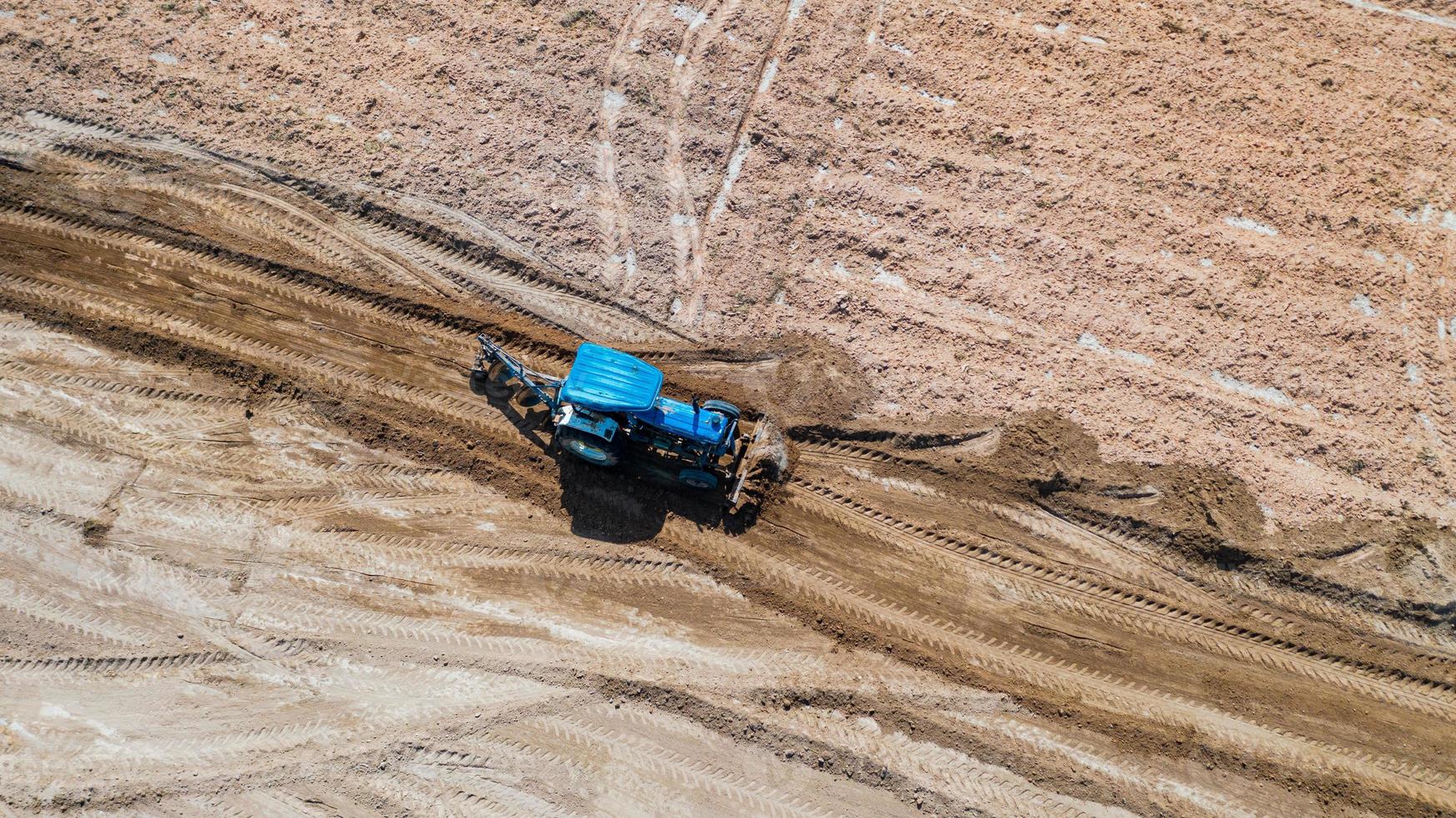 Top view of agricultural tractor vehicles working at field photo