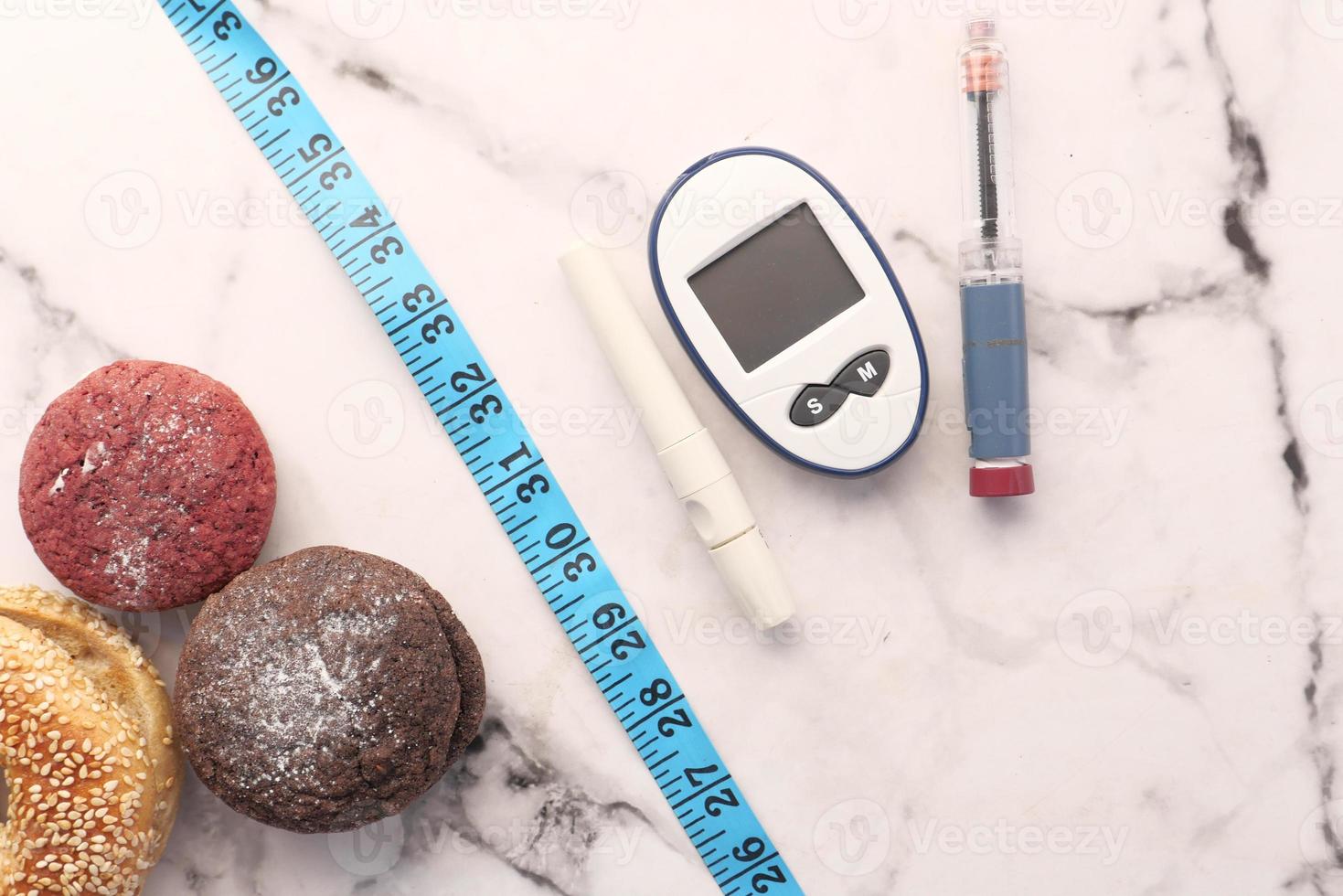 Diabetic measurement tools with insulin and cookies photo