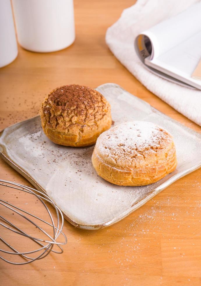 Choux dessert topped with powered sugar photo