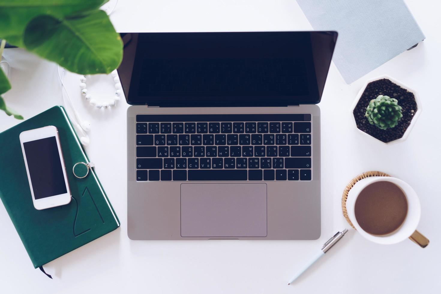 Top view of modern laptop with phone to work photo