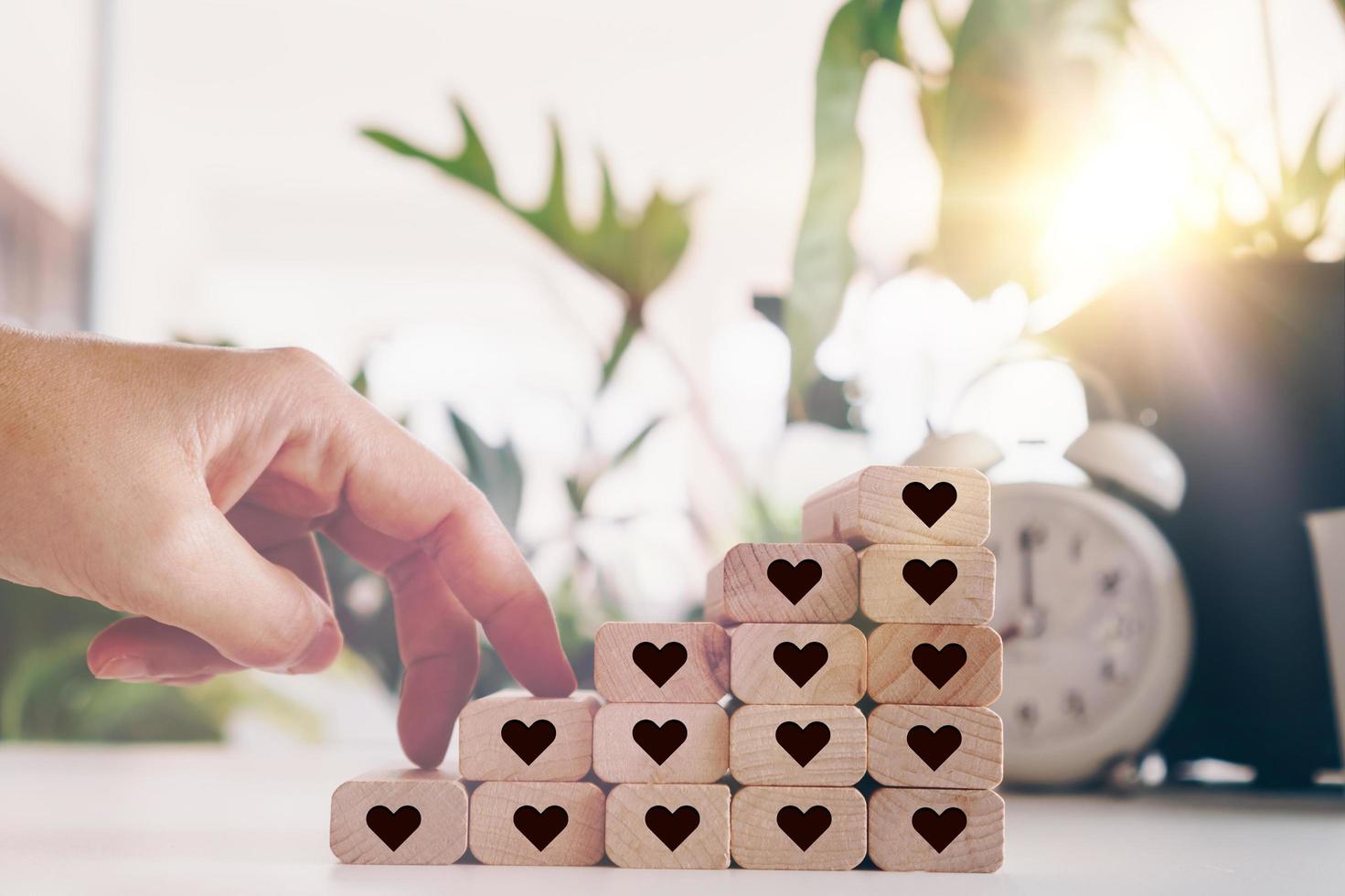 Heart icons on wooden step boards with blank copy space background photo