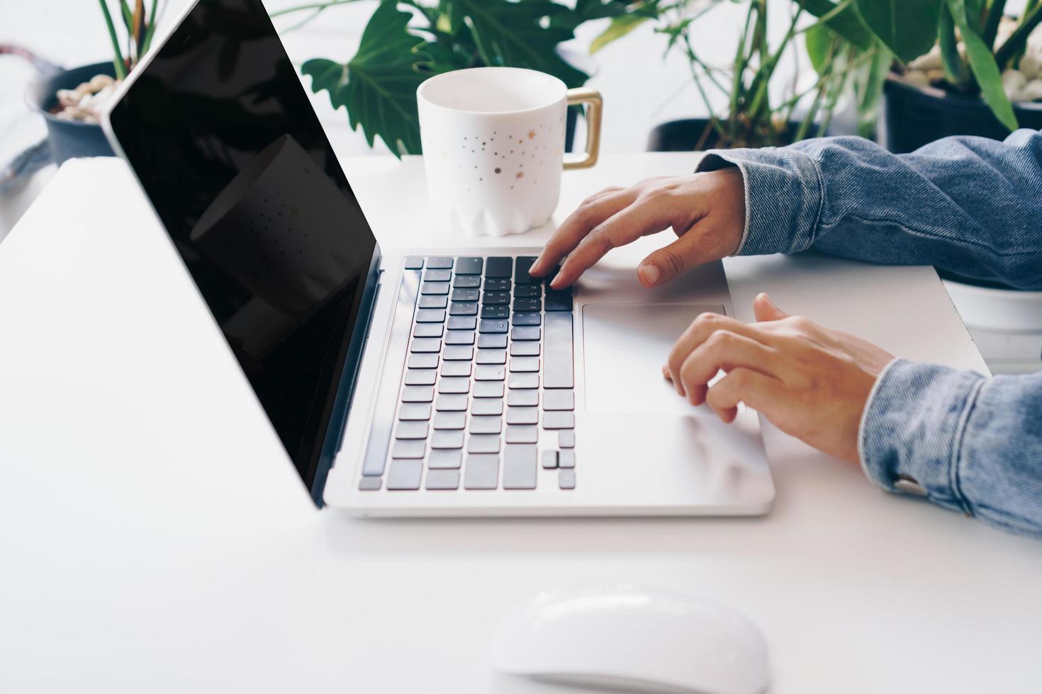 Person using a laptop to work study on desk photo