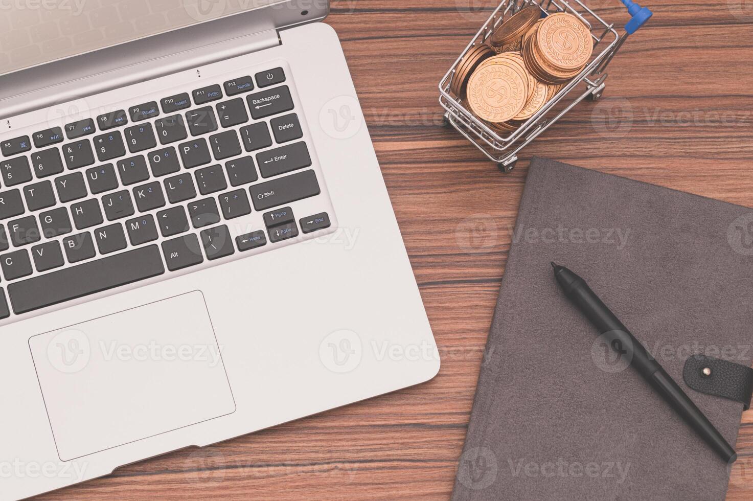 A laptop computer sitting on a wooden desk photo