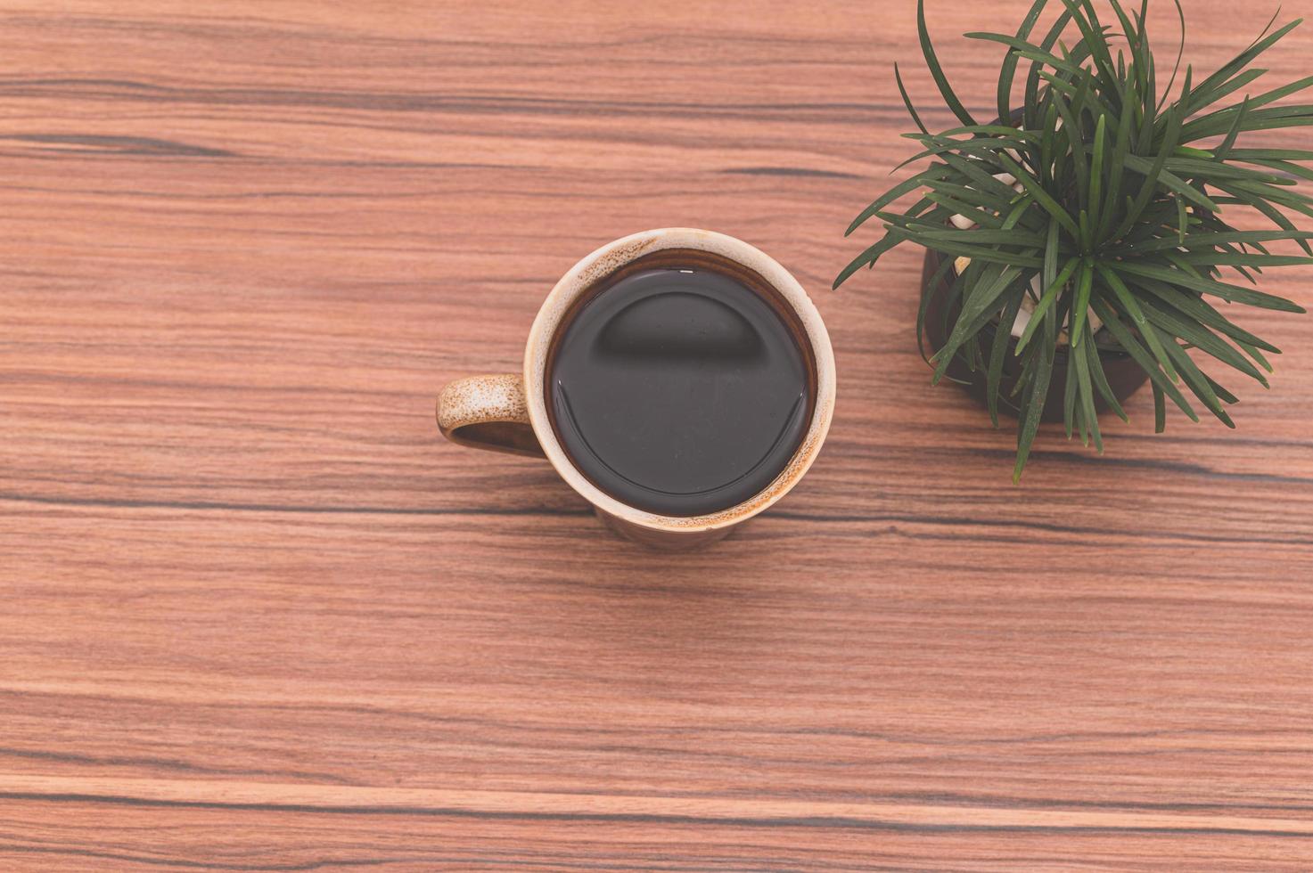 Cup of coffee on wooden table photo