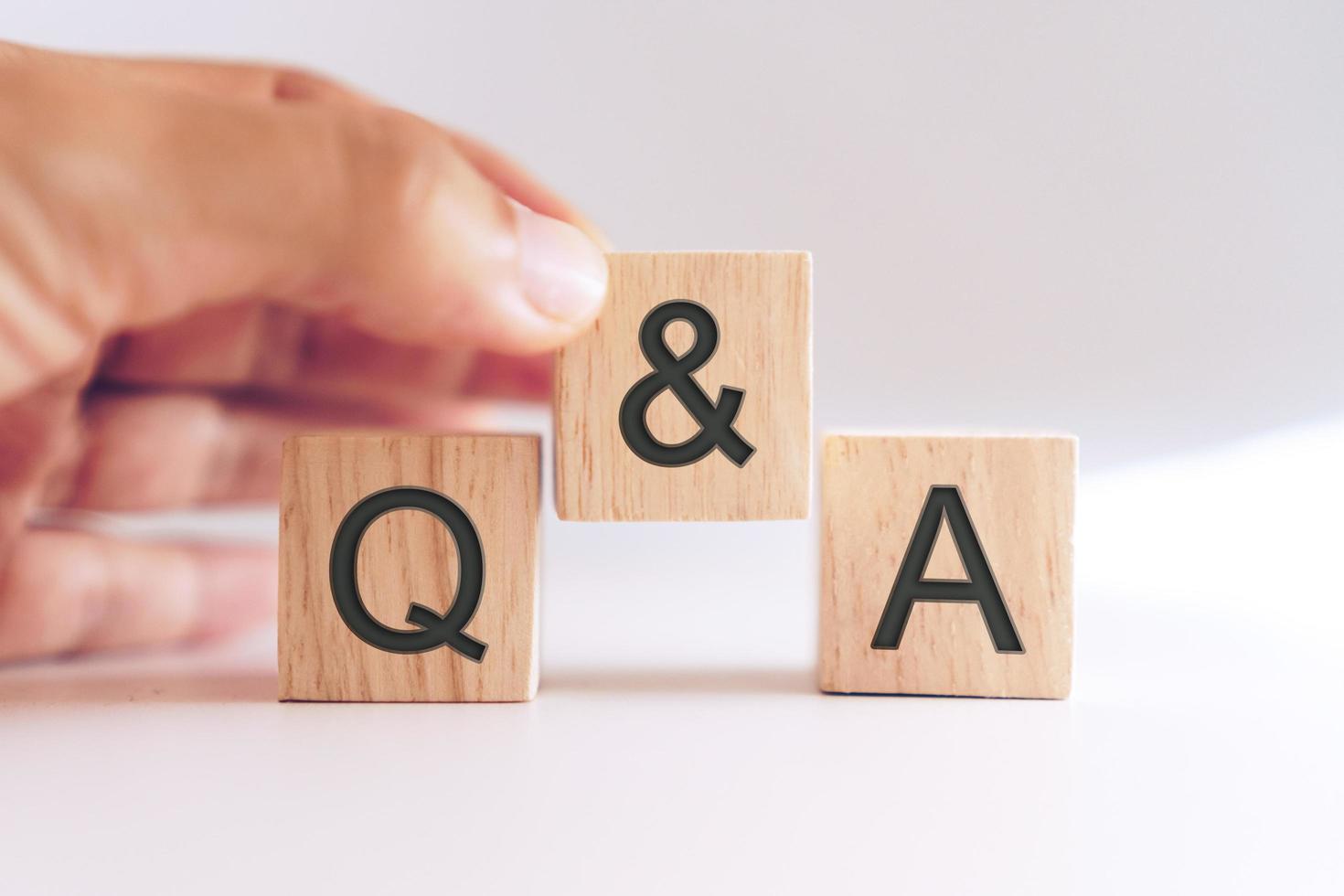 Q and A alphabet on wooden cubes in hand photo