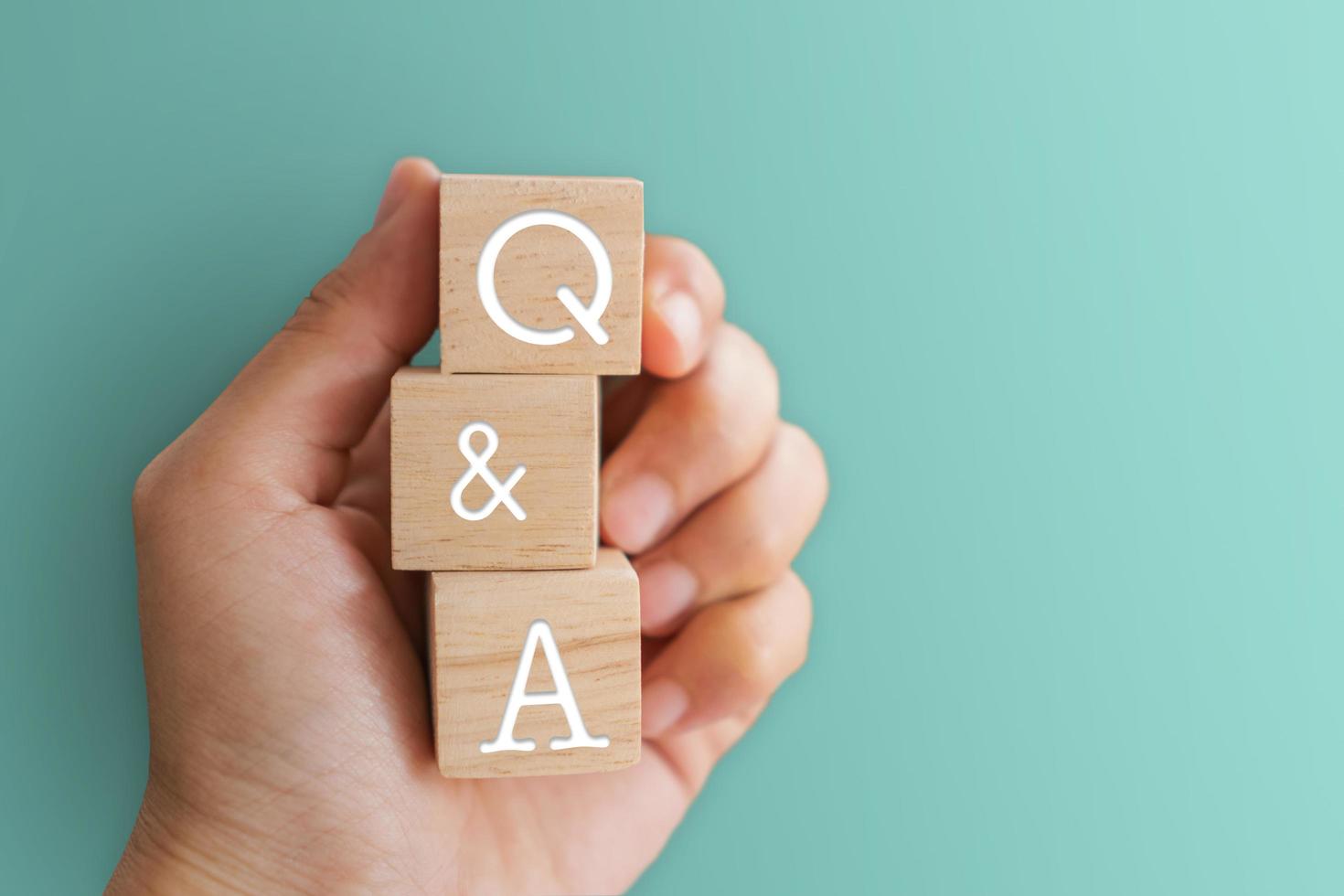 Q and A alphabet on wooden cubes in hand photo