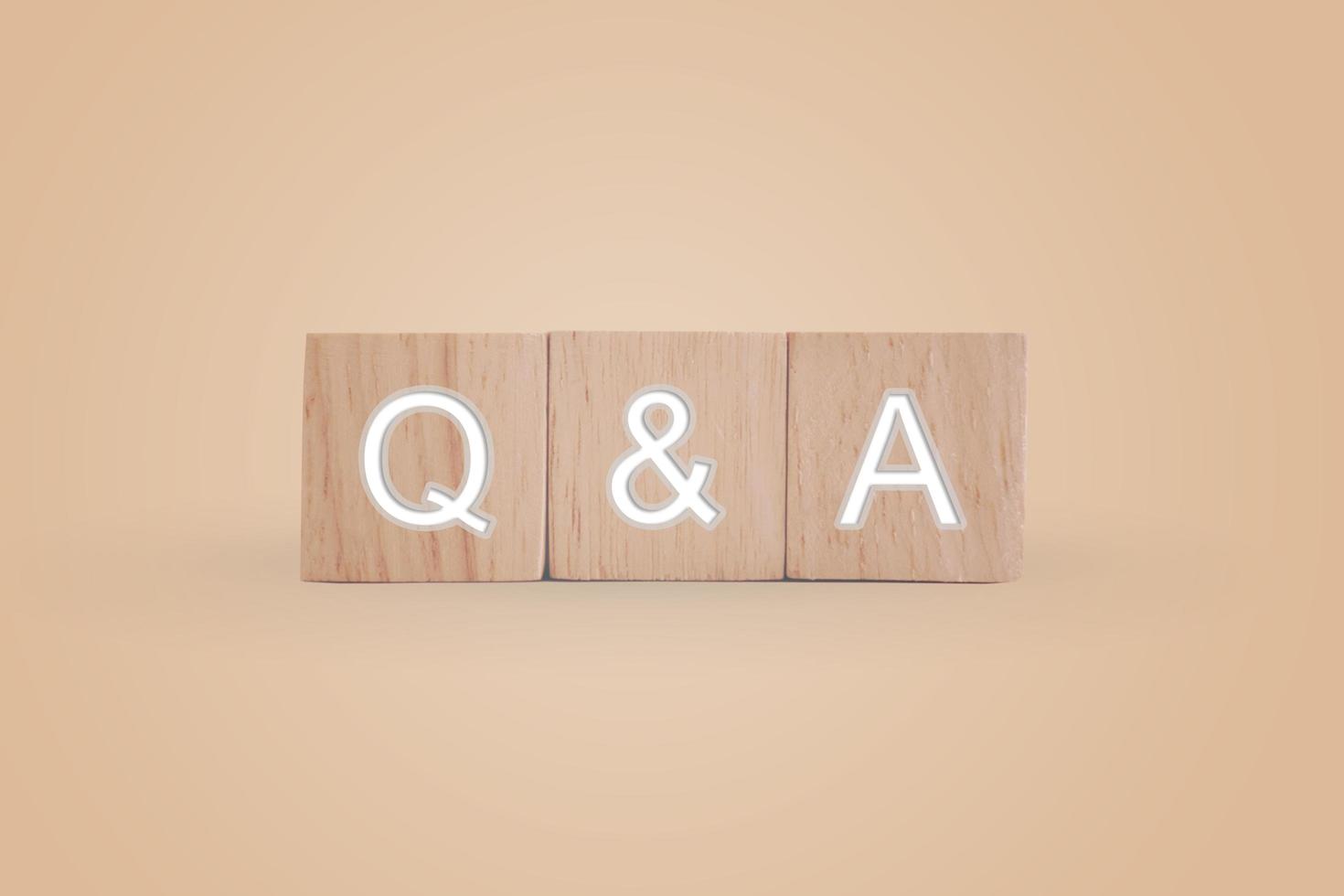 Q and A alphabet on wooden cubes with background photo