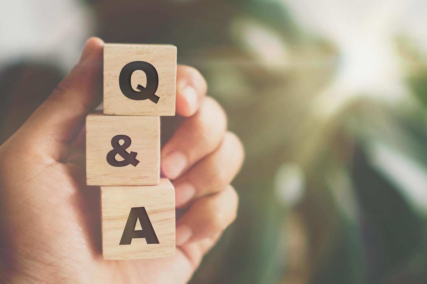 Q and A alphabet on wooden cubes in hand photo