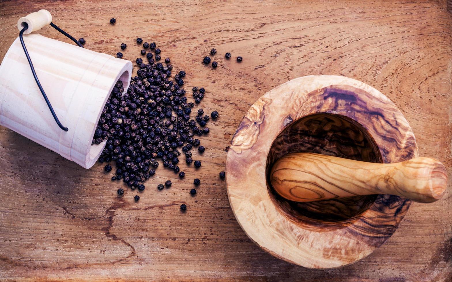 Black peppercorn on wood photo