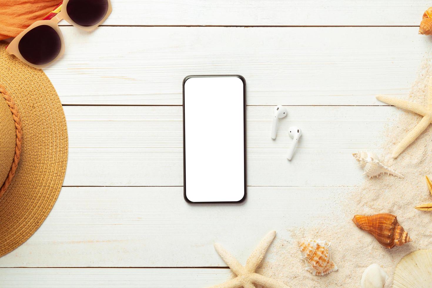 Top view of a smartphone mock-up with summer items photo