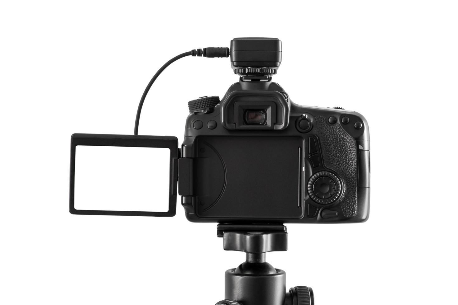 DSLR camera on a tripod isolated on a white background photo