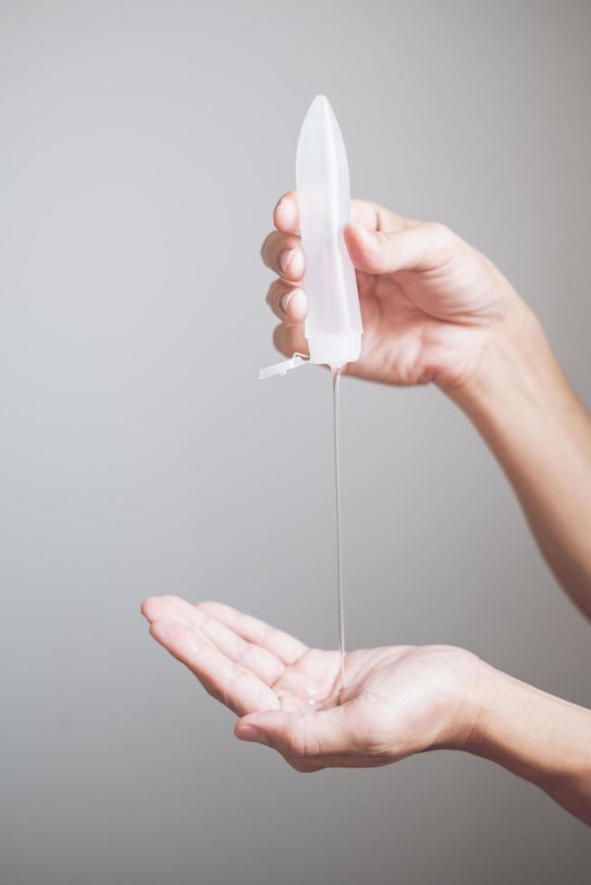 Man hands using hand sanitizer gel dispenser against novel coronavirus or Covid-19, hygiene and healthcare concept photo