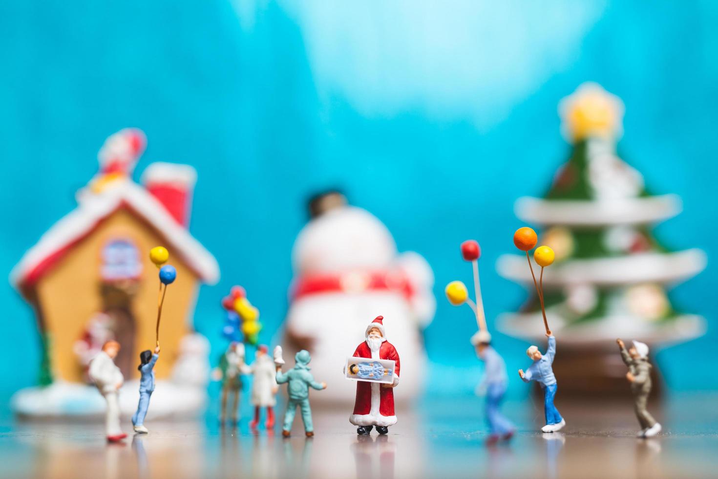 Miniature happy family celebrating Christmas, X-mas and Happy New Year concept photo