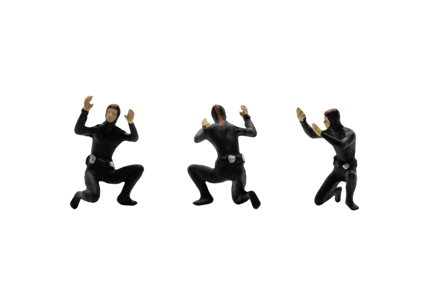 Miniature group of scuba divers isolated on a white background photo