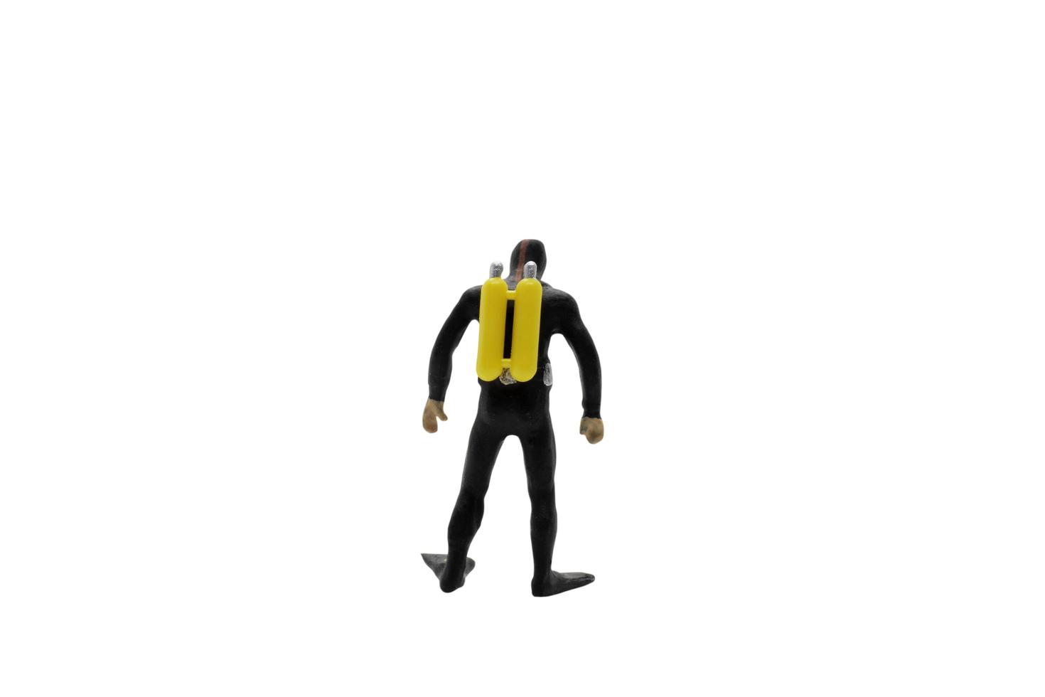 A miniature scuba diver isolated on a white background photo