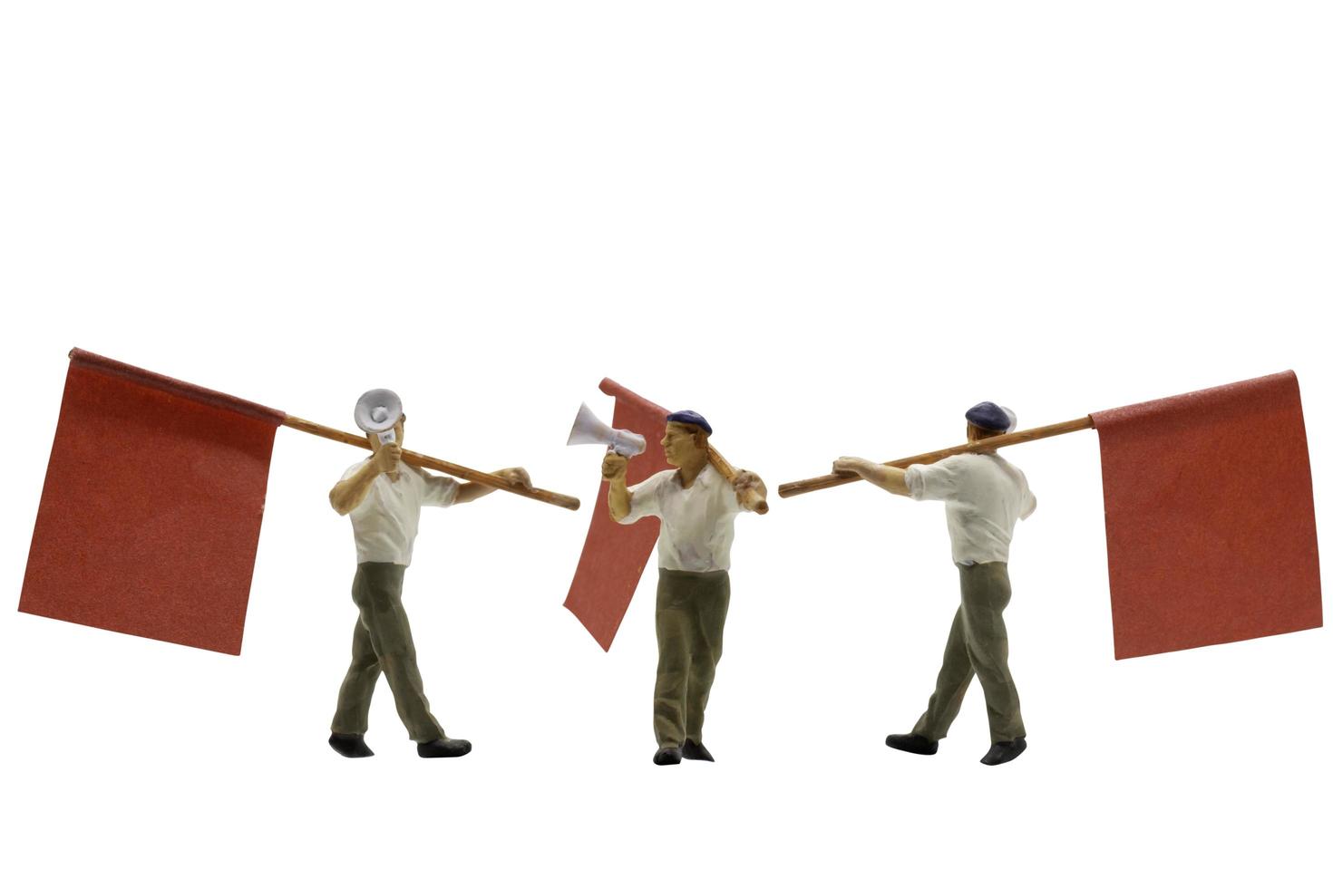 Miniature people holding megaphones with flags isolated on a white background photo